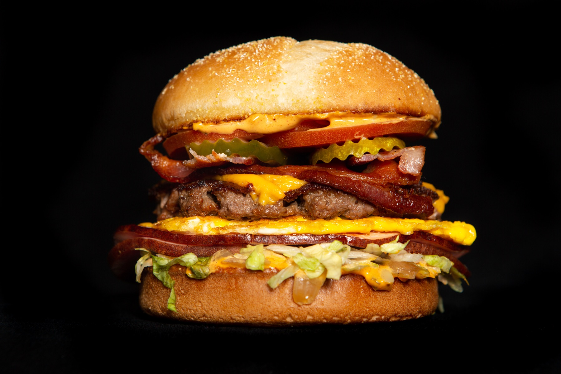 Killer Burger bacon cheeseburger on a dark background